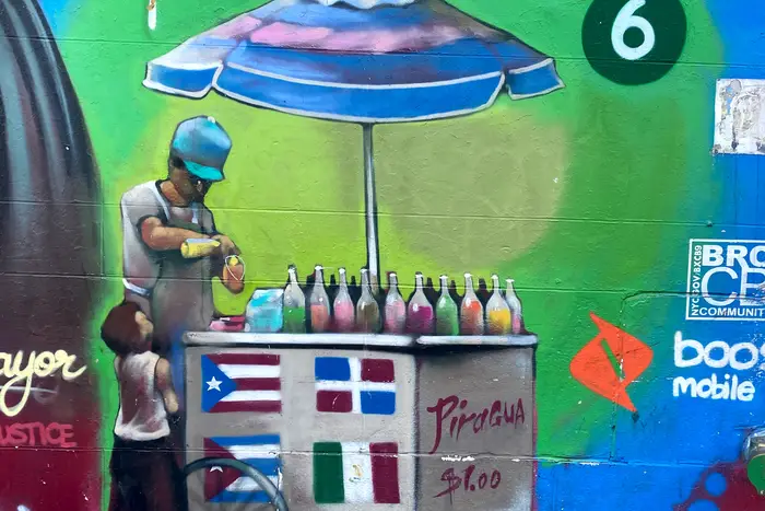 a mural of a piragua vendor